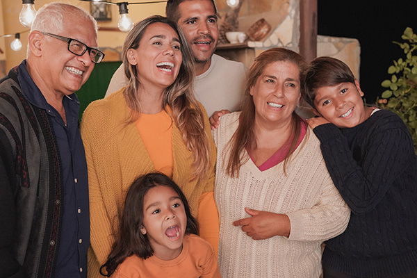 photo of a hispanic family posing for a group photo and smilinng