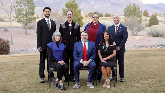 Photograph of seven Alumni Award winners, including Len Kravitz and Leola Paquin, posing outside.