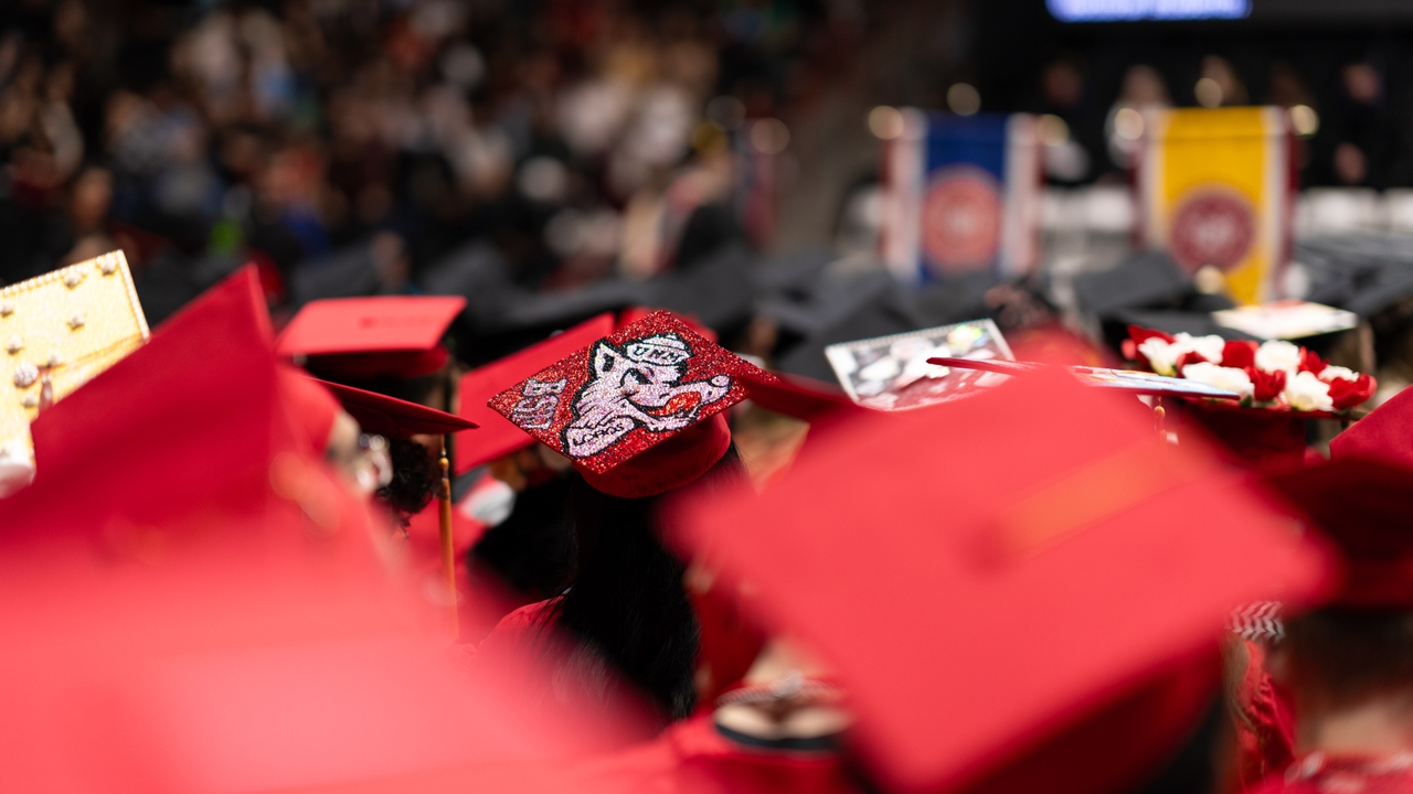 photo of graduation caps on students 