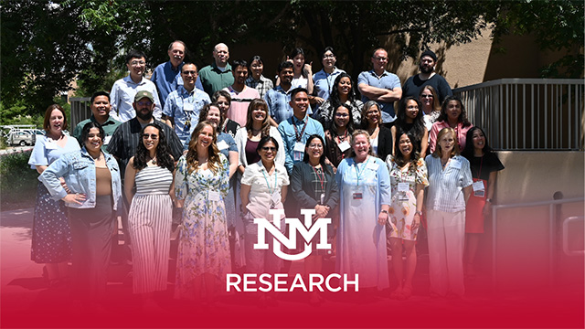 Photo of group of research faculty standing together with UNM Research logo
