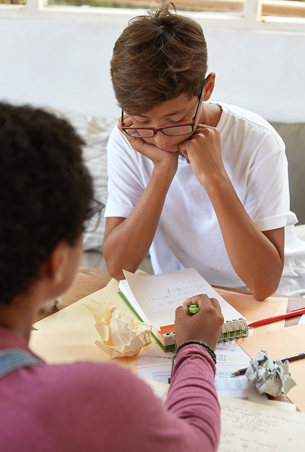 A student and a teacher going through a workbook together